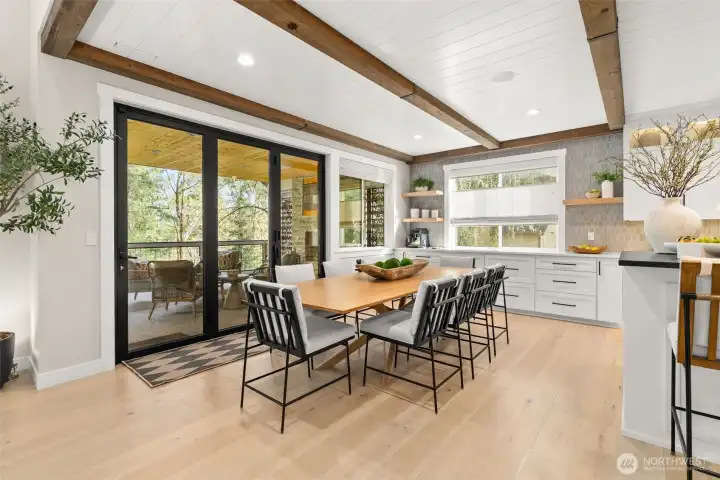 The tri-fold patio door adjacent to the dining space is perfect for indoor/outdoor entertaining.