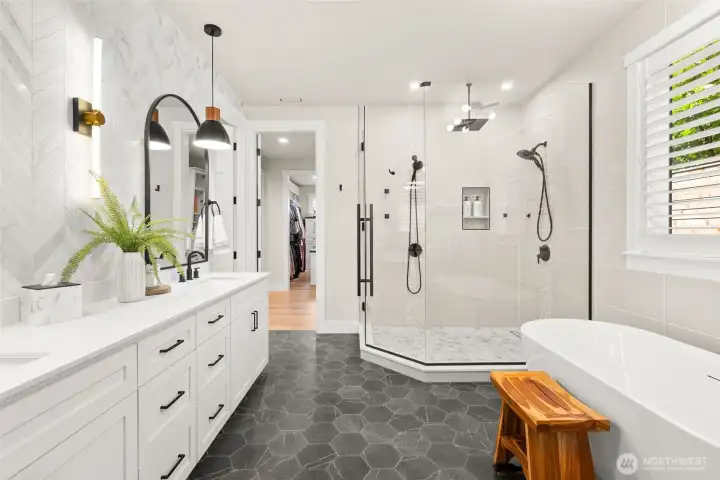 A five-piece bath with double sinks and two shower heads.