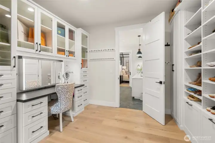 Inside the primary closet is a vanity with a backlit mirror.