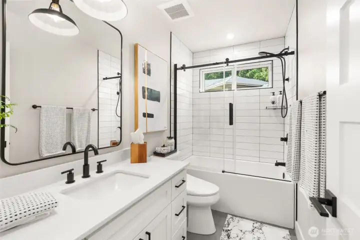 A secondary full bath serving one of the second floor bedrooms.