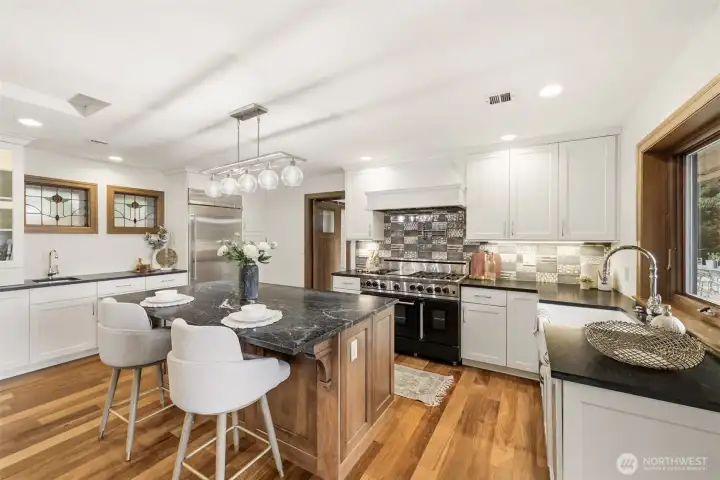 Updated kitchen with a Blue Star gas cooktop & 2-ovens, huge soapstone island, and a convenient wet-bar.