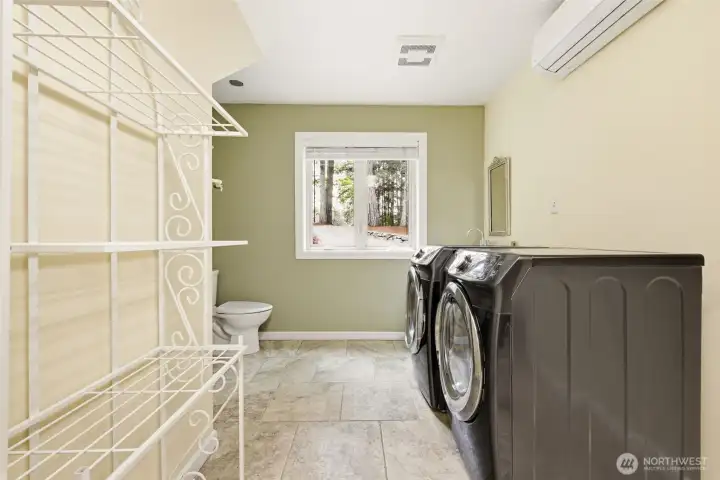 Lower laundry room with half bathroom.