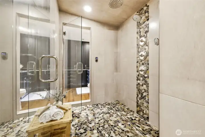 This shower - steam room is in-between the dual vanity & toilets.