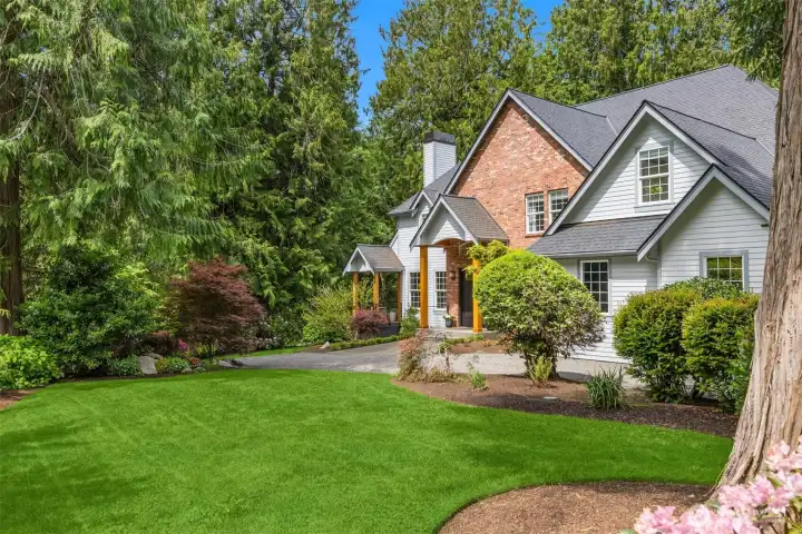 Mature gardens and sweeping lawn spaces envelop the home, offering room to wander and unwind without ever leaving the property.