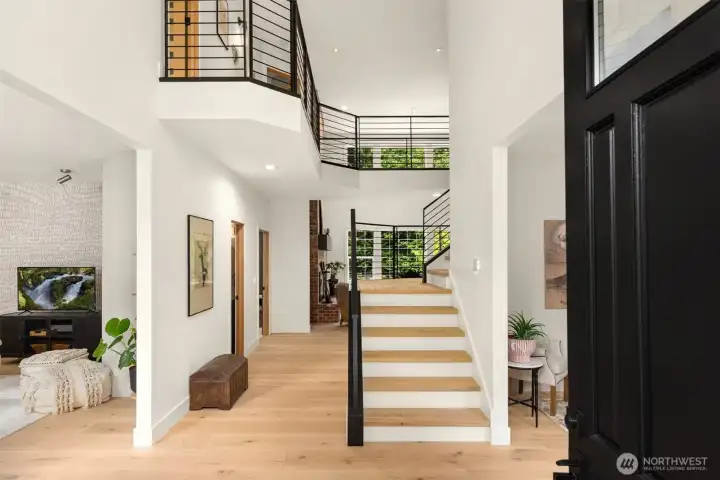 Interior spaces unfold beneath soaring ceilings that lend both scale and warmth, creating an atmosphere that feels elevated yet entirely welcoming.