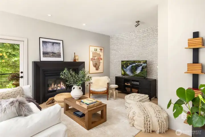 Main floor den with gas fireplace and access to a quiet, covered, HEATED, deck area!