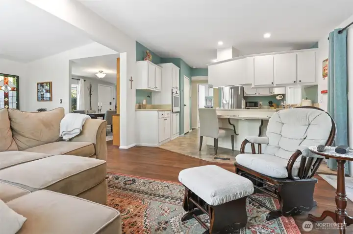 Family room opens to the kitchen and also has a sliding door to the sunroom.  Features vaulted ceilings, LVP flooring and a wood fireplace.