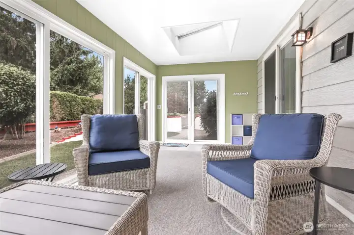 Light and bright sun room accessed from the family room features many new vinyl sliding doors, sun screen shades and skylights.  (Extra 400 sq ft not included in the home size per SCR)