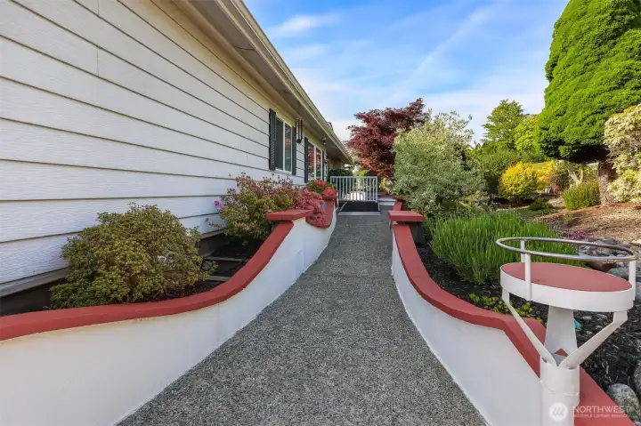 East side entrance to the formal entry way, looking North, with low maintenance landscaping features numerous feet of custom retaining walls