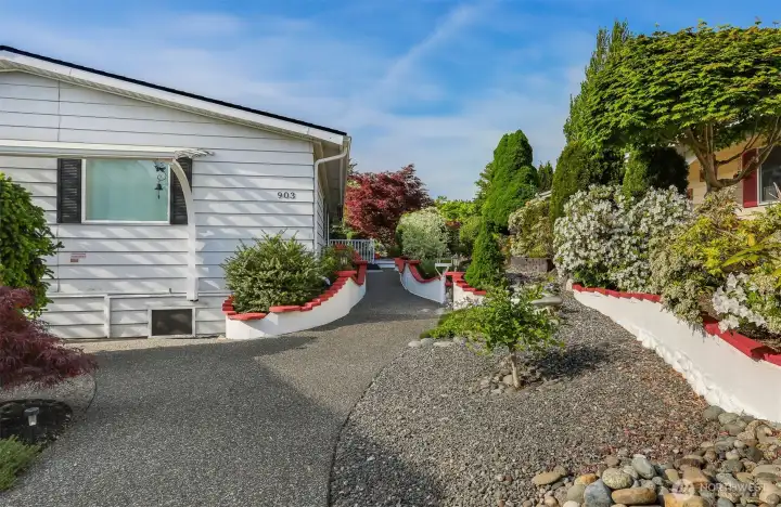 240th St side (South Side) with low maintenance landscaping features numerous feet of custom retaining walls, looking North.