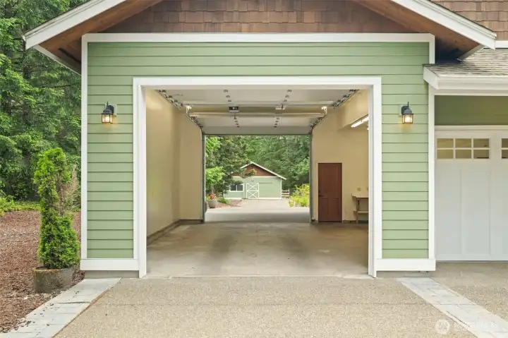 3rd oversized bay of garage drives through toward barn