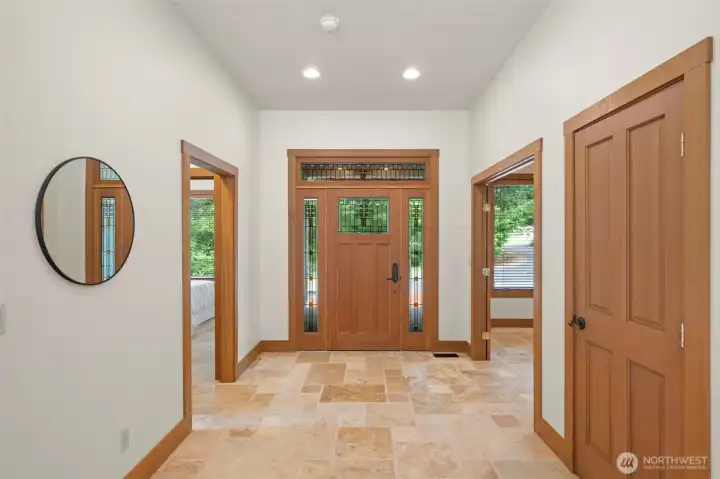 Spacious entryway with beautiful Craftsman-style front door