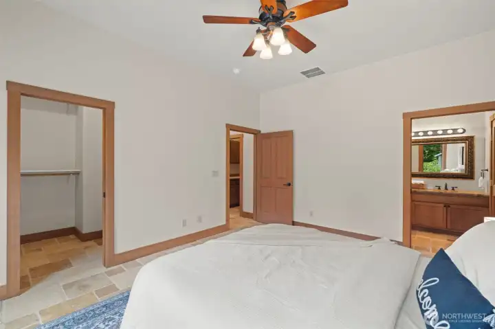 Primary suite with walk-in closet and tile shower