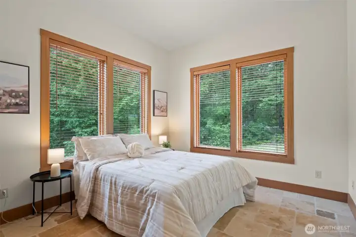 Second bedroom at far end of home from primary suite for maximum privacy