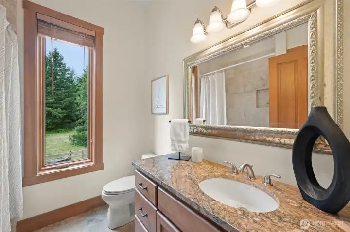 Granite counters and tile bath in guest bathroom