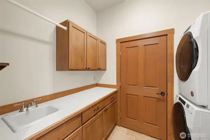 Laundry room with sink leads out to the garage