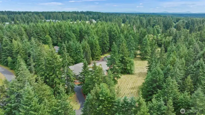 Aerial view from front of property showing home and 2 pastures to the west of home.