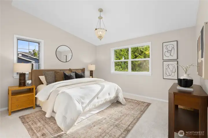 Primary bedroom on the second floor with vaulted ceilings. Primary bedroom on the second floor with vaulted ceilings.