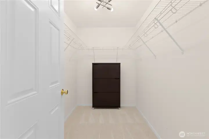 Primary bedroom walk-in closet. Primary bedroom walk-in closet.