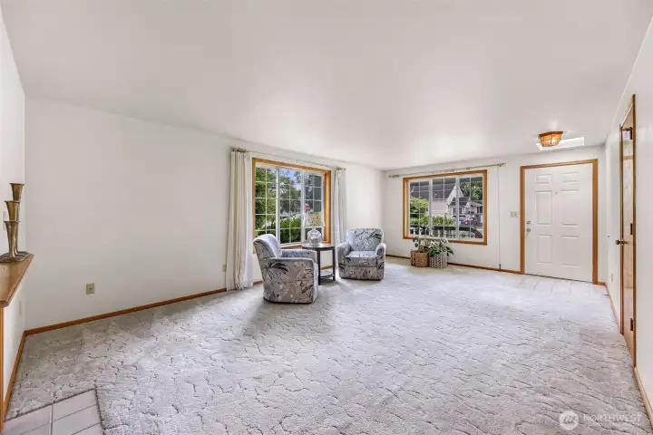 Huge windows and an entryway skylight makes this living area bright