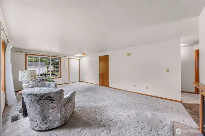 the living roomis open to the dining and to the left between is the hallway to the bedrooms and baths