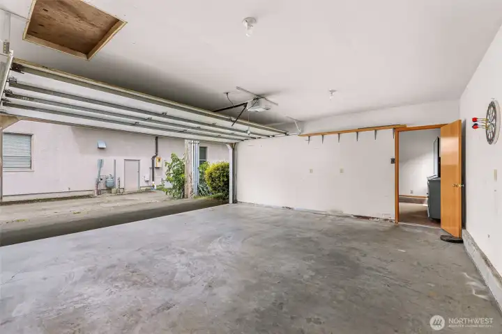 large 2 car garage with an attached bonus room