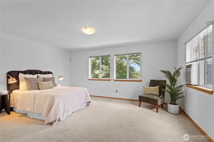 Primary bedroom with view onto the backyard