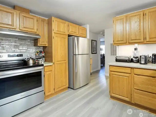 Love to cook? This kitchen is all ready for you, and if you wish to cook or dine al fresco, the stove in the ‘indoor/outdoor’ kitchen is all ready for your use too! You can sit down for a meal at the eat-in kitchen bar, the formal dining room, or take your choice of the ‘indoor/outdoor’ kitchen-rec room, OR the covered back deck. You’ll be able to celebrate life here each and every day