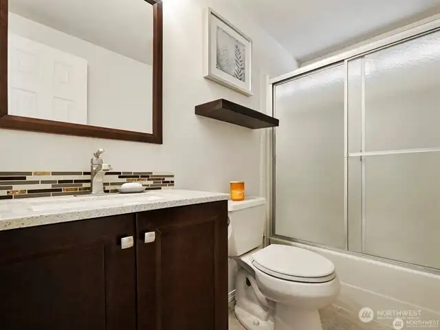 The main bathroom is roomy, gleaming, light and bright, and all ready for you!