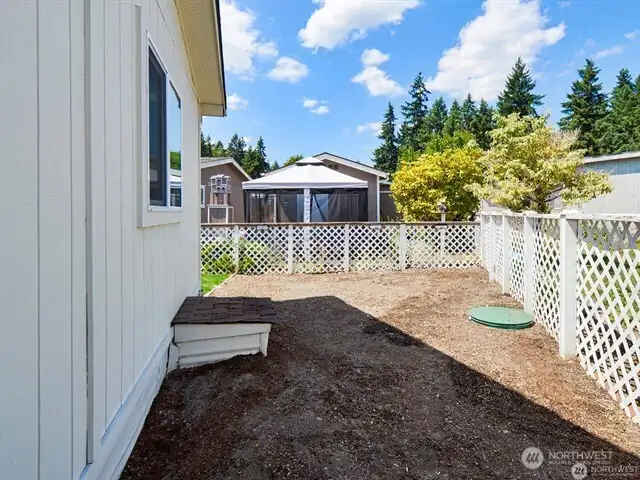 Got pets? The backyard is fully fenced, and includes both a lawn area and a bark area. And you OWN your own lot here - never a space rental fee, so you’ve got 100% security for the long-term! It’s a great home, AND a great investment!