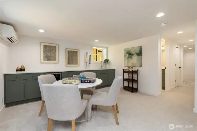 Family room has wet bar and cabinets from one wall to the other