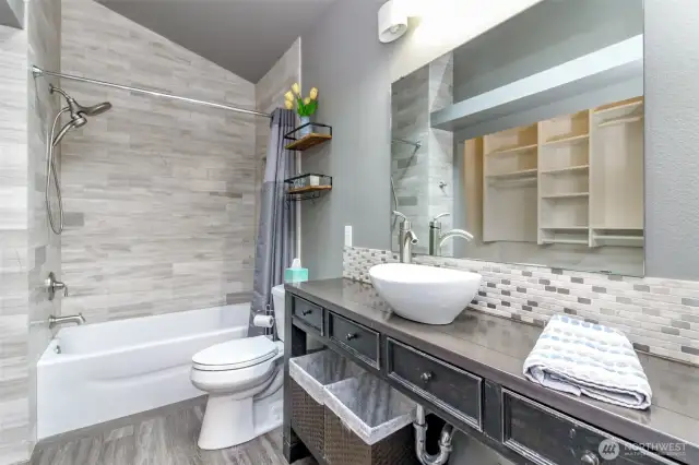 This main full bathroom includes a lovely tile surround & tile backsplash as well as updated fixtures.