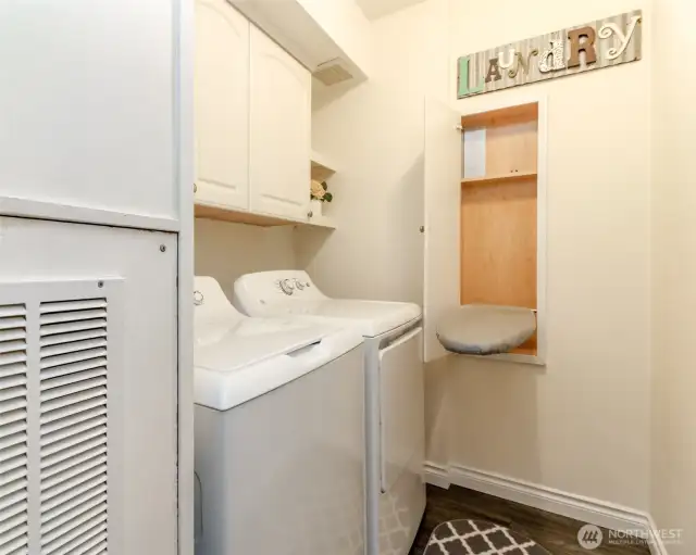 This laundry room includes newer washer/dryer and a custom ironing board built-in!