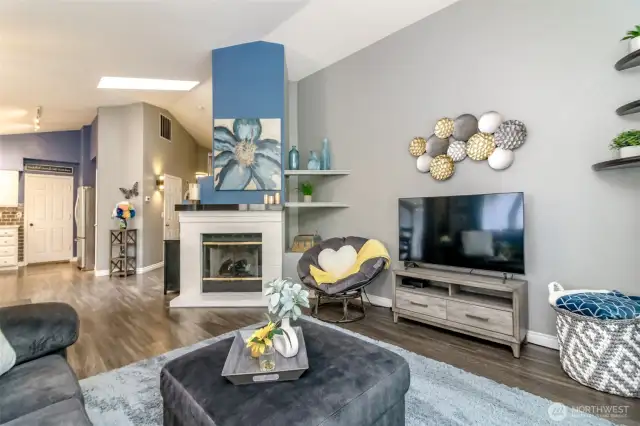 Another view of living area showing the updated paint colors and the beautiful vinyl flooring.