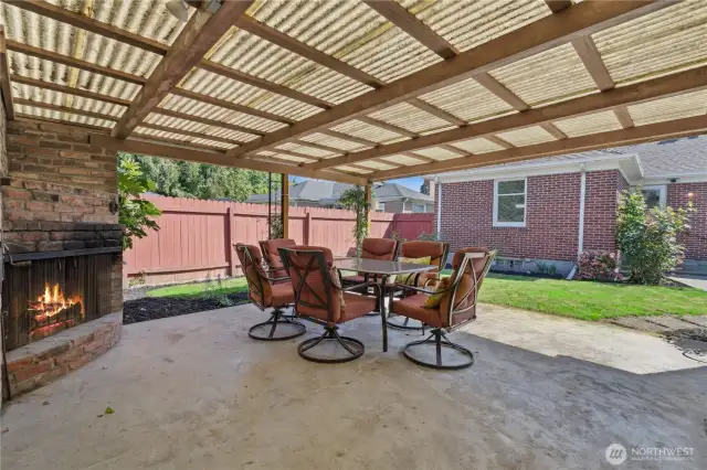 Backyard wood fireplace under thr covered patio making it usable all year round.