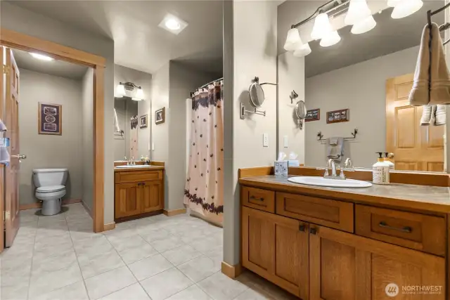En suite bath, with custom quarter-sawn oak cabinets and two vanities.