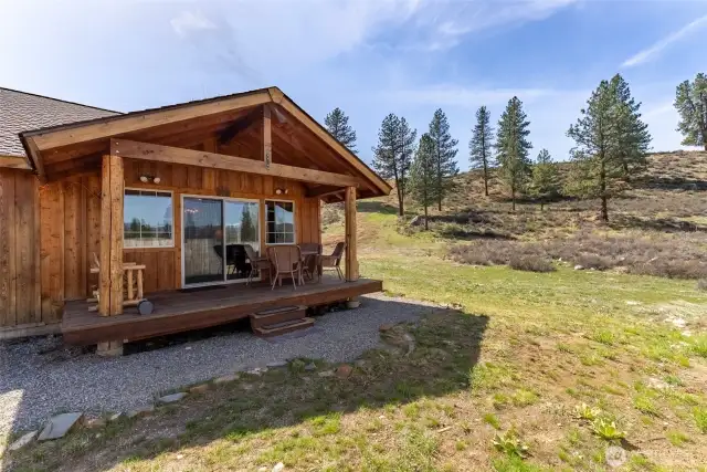 Covered back porch, with room to sit and enjoy the view.