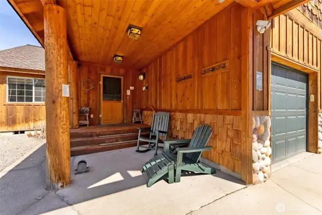 Covered front entry, with room to sit and enjoy the view.