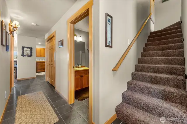 Tiled entry, with stairs on the right leading to the upstairs bedroom.