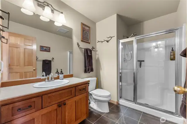 Spacious main bathroom, with custom quarter-sawn oak cabinets and walk-in shower.