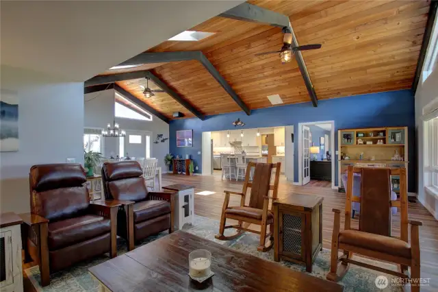 open floor plan view of breakfast bar, french doors to office, amazin open bean ceiling with 2 ceiling fans.