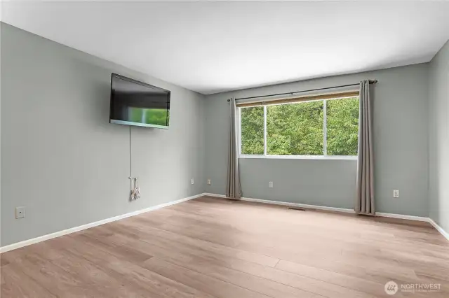 Primary bedroom with view into backyard; TV Conveys