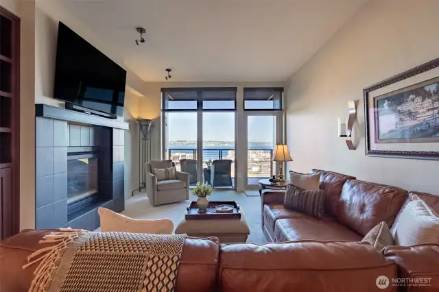The living room has a dual sided fireplace for warmth and ambiance. Spectacular views off the balcony are just one of the many amenities.