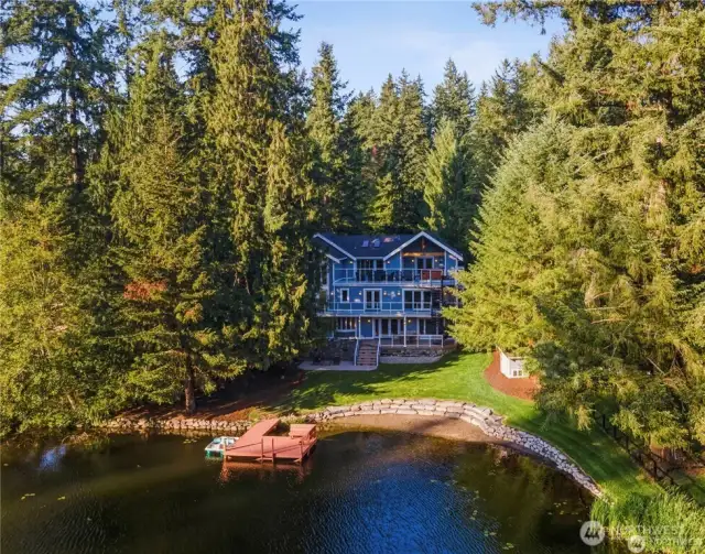 Lake Marcel Waterfront Living with 135' of professionally designed sand beach and rockery wall. Entertaining Dock with bench seating.