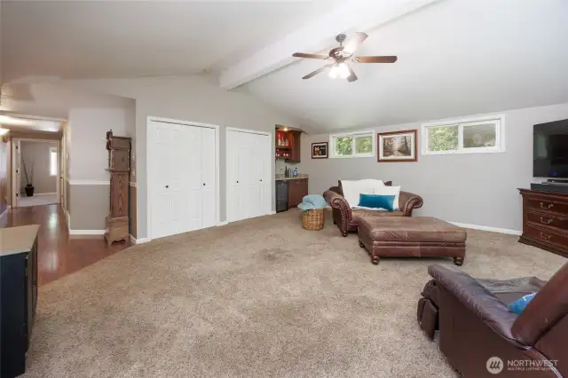 The main floor recreation room offers a wet bar and plenty of windows to view the arboretum-like back yard.