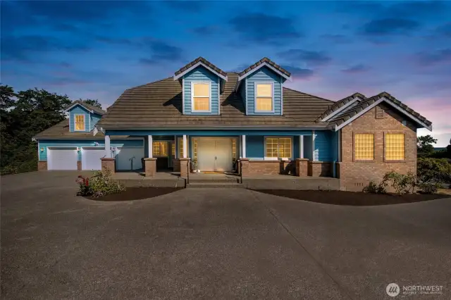 Stunning custom home with timeless curb appeal, inviting porch, and 3-car gara