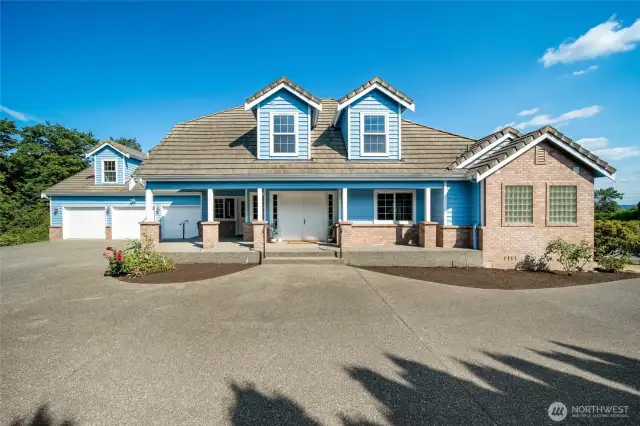 Beautiful custom home with striking curb appeal, inviting porch, and 3-car garag