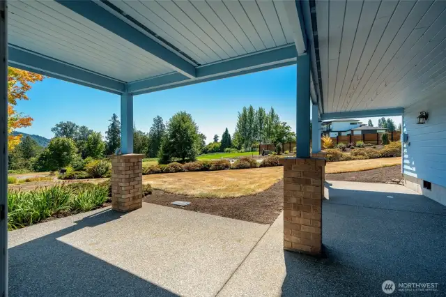 Covered patio with space to relax and enjoy views of the yard and surrounding greenery.
