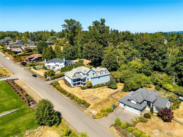 Spacious lot in a well-maintained neighborhood, with a private wooded area providing backyard seclusion.