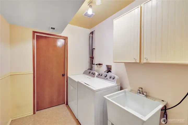 Lower laundry room with huge storage closet.